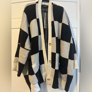 Dressed in LaLa oversized checkerboard cardigan, black and white.